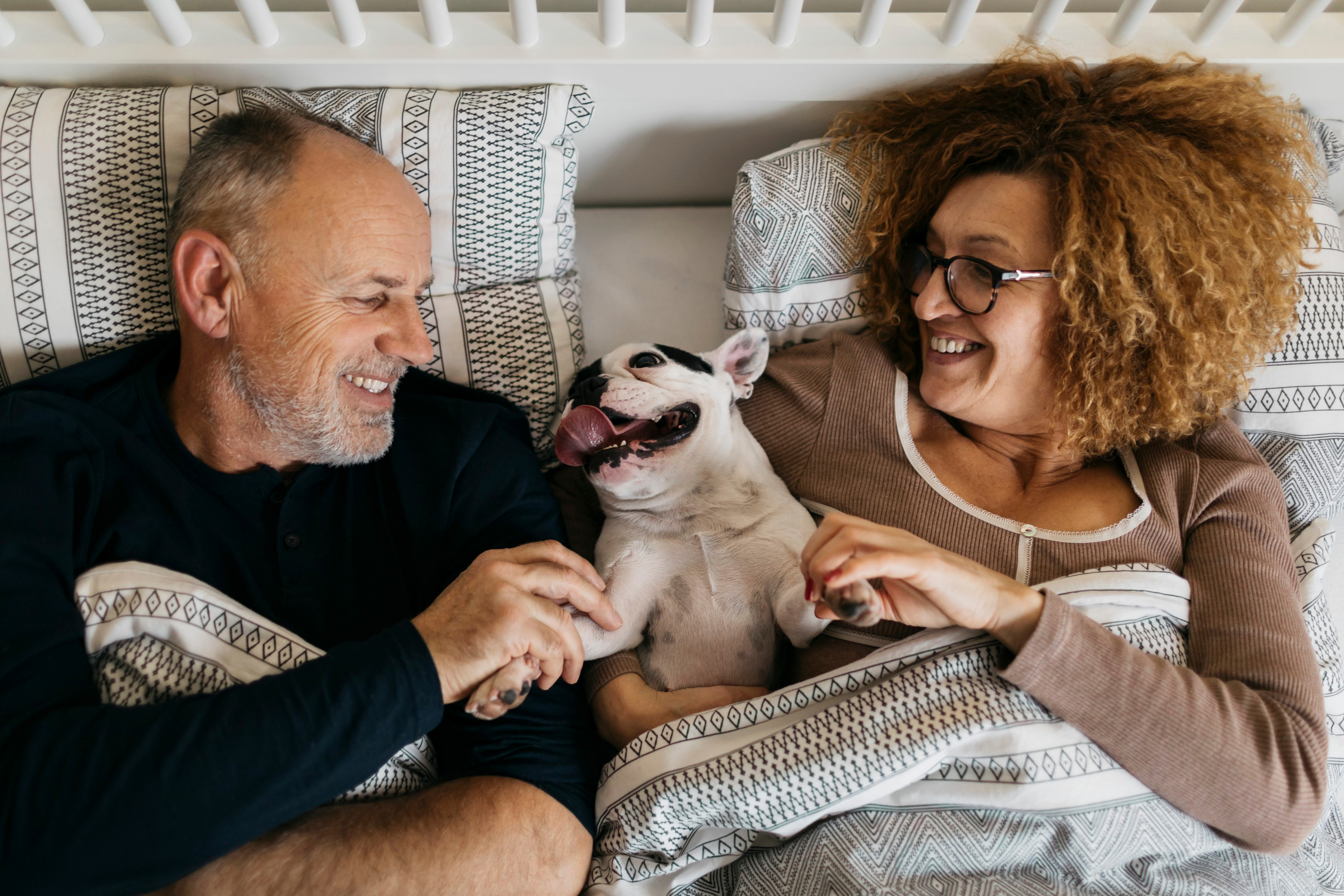 Couple in bed with dog