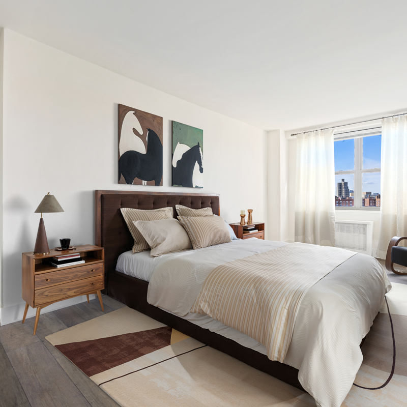 Bedroom with horse posters, brown bedframe, white curtains, dark wood floors