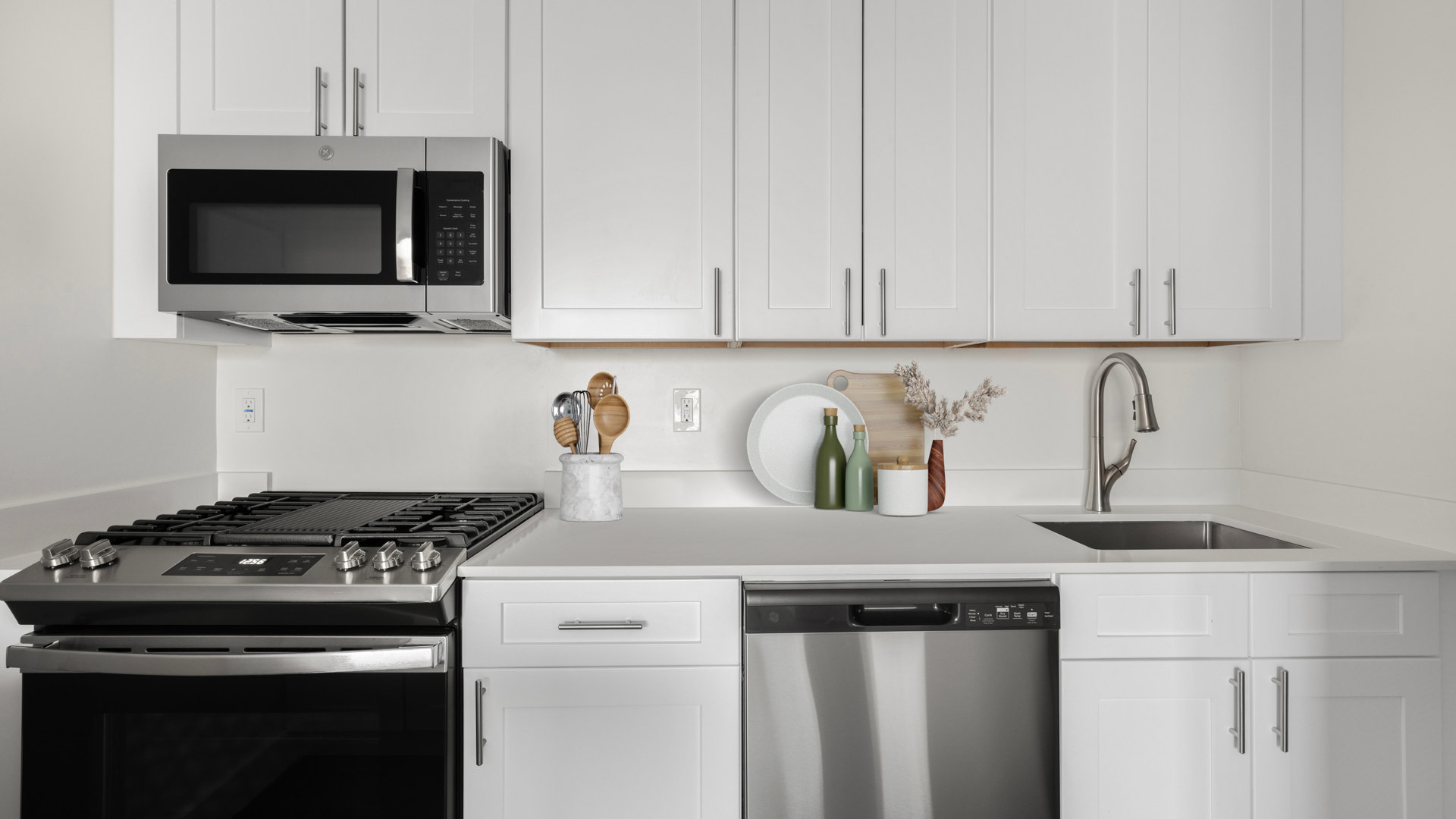 Kitchen with stainless steel, white cabinets, white countertops
