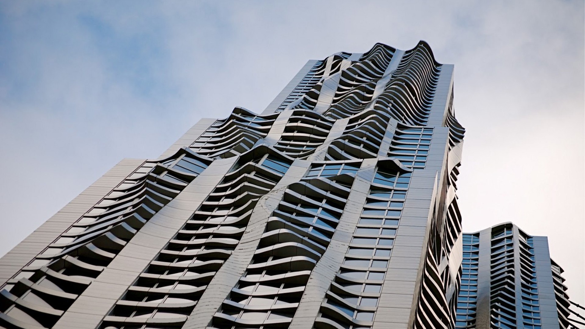 8 Spruce's shimmering metallic facade with flowing steel panels designed by Frank Gehry