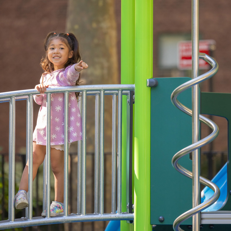 Vertical girl pointing on playground