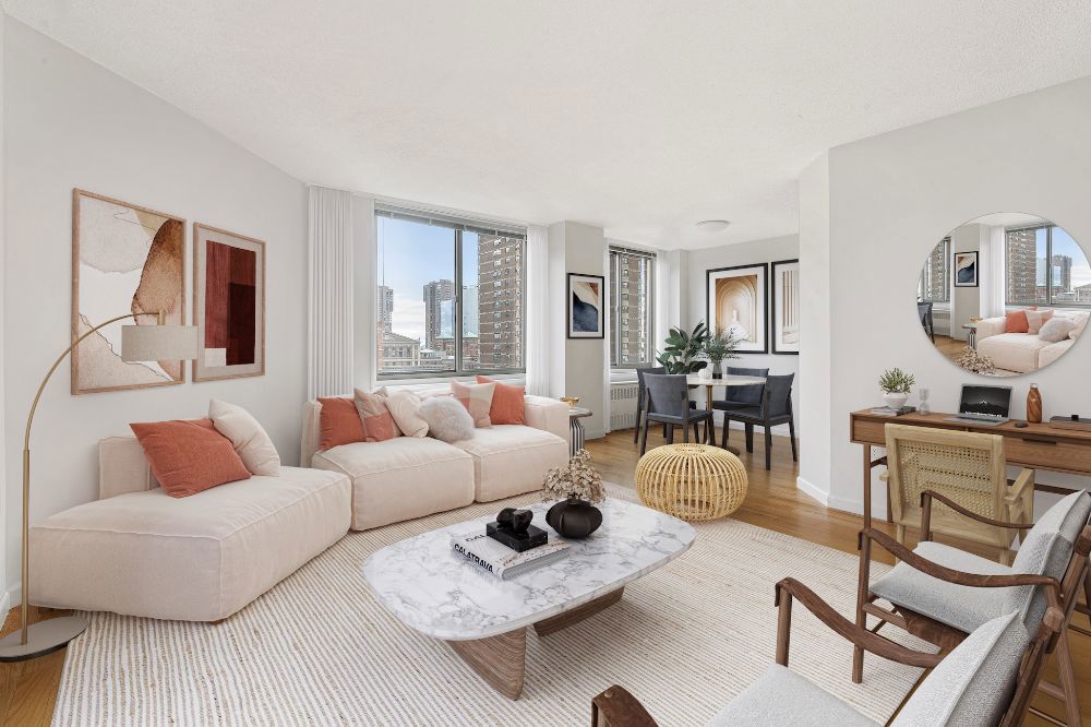 Living Room with White sectional couch, pink/orange accents, dining area, desk